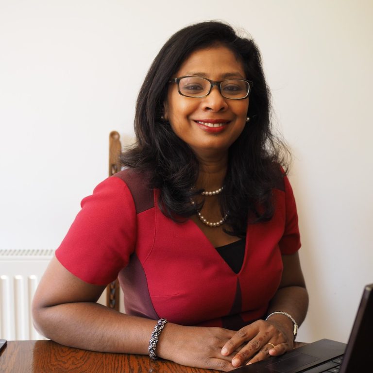 Photo of KB-Dynamics CEO & Founder, Dr Kogila Balakrishnan, sitting at a table